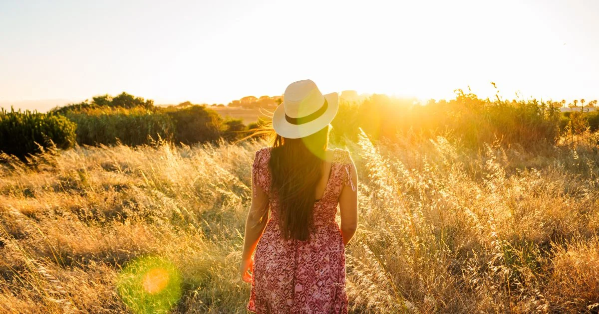 woman looking out in field, reflective; Visionary somatic dance